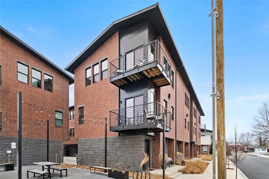 Fall in love with this corner 2 bed, 2.5 bath townhome, located in a prime Downtown Bentonville location, just a short walk or bike ride to the vibrant Arts District and local hot spots like The Momentary, Bentonville Square, Crystal Bridges, Walmart Home Office, and 8th St Market. The spacious open-concept floor plan features a den off the living room, ideal for work or relaxation. The kitchen boasts a walk-in pantry, quartz countertops, custom-built soft-close cabinets, and access to a private covered balcony. Stainless steel microwave, dishwasher, and range are included. Both bedrooms offer walk-in closets and en suite bathrooms. The home features upgraded wood flooring on the third floor landing and staircases with Sisal runners, wool Berber carpet in the third-floor bedrooms. Custom wallpaper adds elegance throughout, and Graber shades provide style and privacy. Additional cabinets throughout enhance storage, making this townhome the perfect combination of style and functionality.