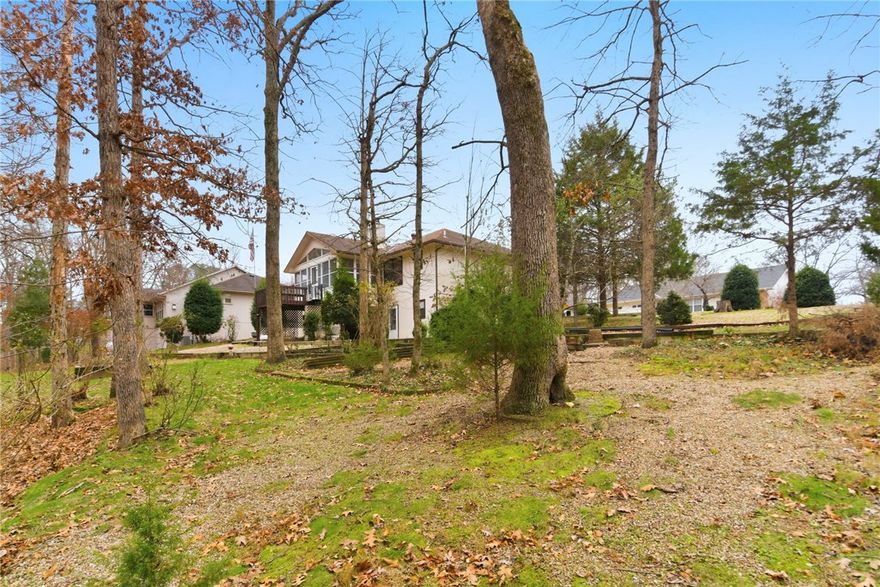 Prime Bella Vista location near Blowing Springs and miles of NWA's top biking and walking trails! This well maintained, one-owner home may feature some dated finishes, but it has been exceptionally cared for from day one. The sale includes the additional lot next door creating a rare, oversized property with extra privacy and room to expand. A private path leads around to the backyard, where a natural wooded barrier offers excellent screening from the road - ideal for RV or trailer parking. Inside, enjoy 3 bedrooms, and 2 baths. Property also features an additional garage/workshop plus a heated and cooled bonus room, perfect for hobbies, office or workout space. Located on a quiet cul-de-sac in the Bentonville school district with quick access to parks, shopping, and the Bella Vista greenway system.
Additional lot will not be sold separately.