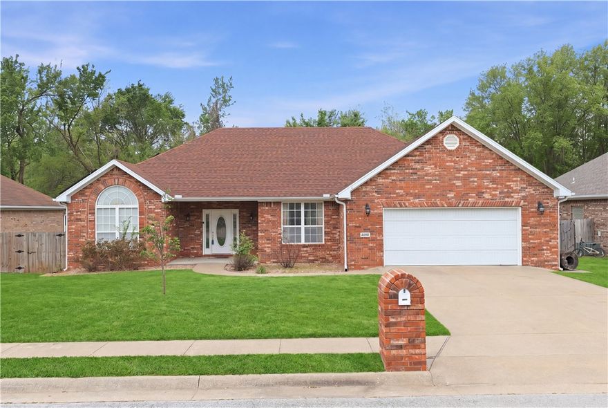 Welcome home to this well-maintained brick beauty nestled in the heart of Whispering Timbers! This 3-bedroom, 2-bath home offers 2,089 sq ft of comfortable, single-level living in one of Rogers' most established neighborhoods — just steps from Reagan Elementary and 5 minutes to I-49. Imagine morning coffee on the back deck while overlooking a tranquil wooded field, evenings gathered around the gas fireplace, and weekends spent in a community where neighbors actually know each other. A park with trail is just down the street! The thoughtful layout features a formal dining room perfect for hosting, an office nook, and a generous laundry room. A new roof (2022), solar panels, attached 2-car garage, and shed with electric mean the big things are already handled — so you can simply settle in and start living.