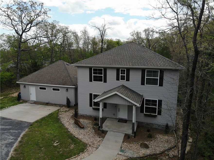 Spacious, Secluded Living in the Heart of Gravette! Beautiful 2-story home is offering 2,601 sq ft, 4 bedrooms, and 2.5 baths. Tucked away on 1 private acre, this property offers the perfect blend of peaceful seclusion and convenient in-town living. This home features vaulted ceilings, a huge living room perfect for entertaining or a home theater, and a main-floor master suite with walk-in closets. The eat-in kitchen includes a large island and walk-in pantry, providing plenty of space for cooking and gathering. Enjoy both a formal entry and convenient mudroom entrance. Step outside to a large back deck overlooking the huge fenced backyard, ideal for entertaining. The professionally landscaped front yard adds great curb appeal. Located just minutes from parks, schools, and walking trails in Gravette, Arkansas, this home offers the rare combination of privacy, space, and convenience.