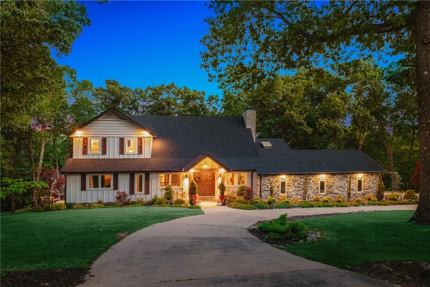 Nestled on 3.04 private acres near Beaver Lake and just 10 minutes from Downtown Rogers, this fully updated 4BR home offers luxury, privacy, and incredible amenities. Upgrades include updated roof, HVAC, windows. Inside features vaulted ceilings with wood beams, stunning fireplace, and large screened porch overlooking wooded views. The renovated kitchen boasts waterfall-edge quartz, custom cabinetry, stainless appliances, gas cooktop, pot filler, and unique antique brick detail. Main-level primary suite includes porch access, walk-in closet, and spa-like bath. Upstairs offers 2 guest rooms with Jack-and-Jill bath, plus private balcony access. Walk-out lower-level features huge bonus room, fireplace, full second kitchen, 4th bedroom, and full bath—ideal for guests or multigenerational living. Stunning outdoor living areas including covered patio and built in firepit surrounded by wooded privacy. Property includes a 2240 sf shop with bathroom, large chicken coop, frisbee golf trails & more! A truly rare find in NWA!