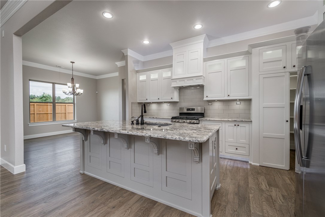 Just finished new Cornerstone Construction home! Was going to be used as their model-but now available! Loaded with quality & upgrades throughout! Beautiful hand made custom cabinetry w/ soft close hinges & drawers, 5 year warranty on all Stainless Steel Energy Star Appliances, including refrigerator! The abundance of mood lighting (all lighting LED) adds to the happy feel of this home with tons of natural light coming from the large pane-less Energy Star windows! Never run out of hot water with the tankless hot water heater, & save $ on electric bills! 20 year finish hardwood, granite counters, wired for surround sound, stained Privacy Fencing, & much more! Hurry, this one won’t last long! Located near Bentonville High School West!