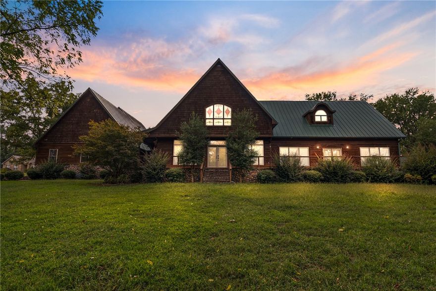 uxury Living on 3 Ac w a shop! Discover this impressive lodge style 5K+sf estate offering perfect blend of elegance & function.. Sits on 3.09ac, offers 5BR, 4.5BA & mult living areas. Has 2 Primary Bus (one upstairs, one downstairs) & 2 optional living areas. Heart of the home boasts a spac kitchen opening to 2 living & 2 dining areas w tons of natural light from the East facing windows. You will love the cat walk/balcony overlooking downstairs. It offers large bathrooms, walk-in closets, a bonus room & incredibly peaceful views of a rolling property. Rare highlight of this home is the safe room & basketball court inside the garage providing endless recreation & fitness opportunities ! For hobbyists the 32x50 shop is incredible and a must see! There is over 1000sf of porch/patio space. This 3 acre property is beautiful, manicured, and has room to garden, play, or simply relax. This one-of-a-kind property provides upscale living with unique decor perfect for a lifestyle that values both!