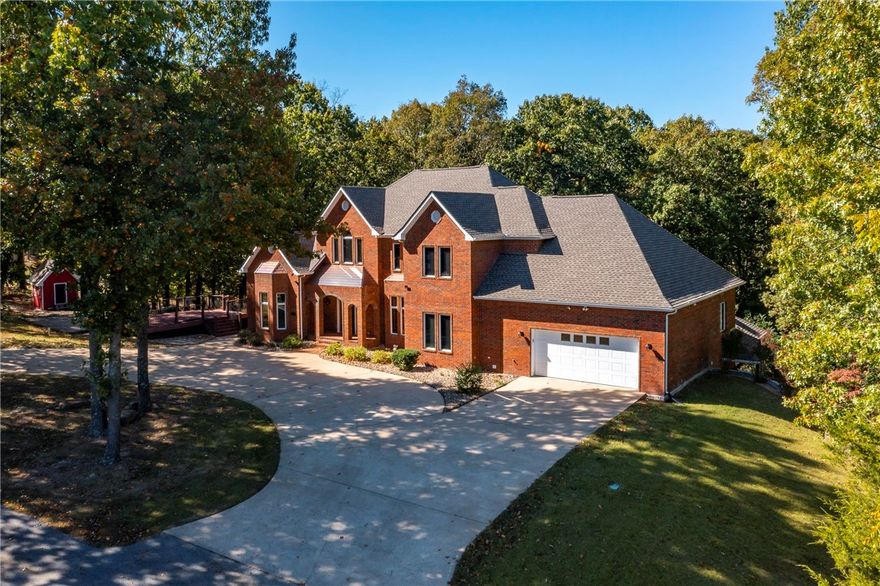 Contingency continue to show. Resting on 1.6 acres, a lavish bounty of natural splendor wraps this gorgeous custom-built home with unprecedented forest-like grounds while nestled near Beaver Lake  Check out the sunset  from your beautiful viewing deck. Full of impressive details, this 5 bedroom 4.5 bath home has living areas on 3 levels. The master suite offers a generous layout, a huge walk-in closet, and a spacious bathroom and fireplace . Downstairs is a separate complete living space. It features an open floor plan and offers many options for your use. It is finished with a wood-burning fireplace for chilly nights, Downstairs has 2nd kitchen, a wet bar, bedroom and bonus space, 2nd washer /dryer connections and, utility closet conveniently nearby. Some like it hot & some like it cold! The main level , upstairs and downstairs have separate HVAC units to make each level comfortable & efficient. The separate garage/ workshop will house your beach toys. Live in luxury,