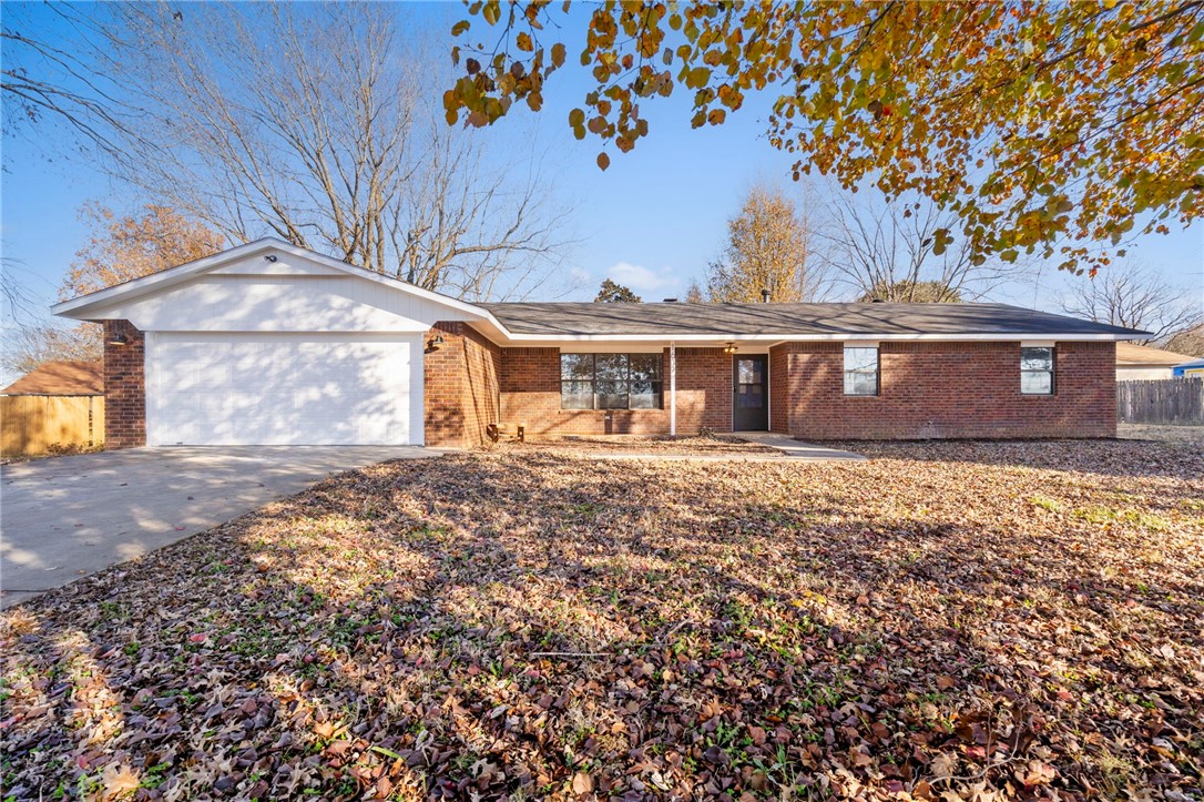 An exceptional, newly renovated home sitting on a wonderful flat .58-acre lot in the heart of Northwest Arkansas! Easy access to I-49, shopping, dining, fitness and much more! It's a perfect blend of modern upgrades and classic charm, surrounded by beautiful mature trees. Inside, the open-concept living area is flooded with natural light and warmth, centered around a grand fireplace. All new paint inside and updated paint on the trim outside. All new flooring, lighting, backsplash, countertops, vanities, bath/shower, and fixtures. This 3 bed, 2 bath home is a must see! Refrigerator Conveys.