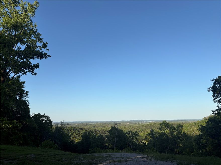 Gorgeous, buildable 2.22-acre lot on the Arkansas/Missouri border in Holiday Island. Perched high on Summit Drive, this wooded hilltop setting delivers breathtaking views and the kind of privacy that feels like your own kingdom—truly a “king or queen of the hill” opportunity. Located on a quiet, paved street with electric at the road and public water available, it’s ready for your dream build. Enjoy the perfect balance of seclusion and convenience, just minutes from golf, marina access on Table Rock Lake, pools, tennis, parks, and scenic walking and biking trails. Nature, views, and amenities—all in one exceptional location.