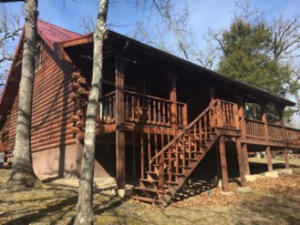 Country Log Cabin on Bull Shoals Lake. This cabin has been updated in many areas over the years. Recent new flooring,. Cabin and 3 lots.Nice large remodeled master bedroom and bath. Sit on the deck and be close to the lake. Partial lake view in winter months. Home being sold as is.