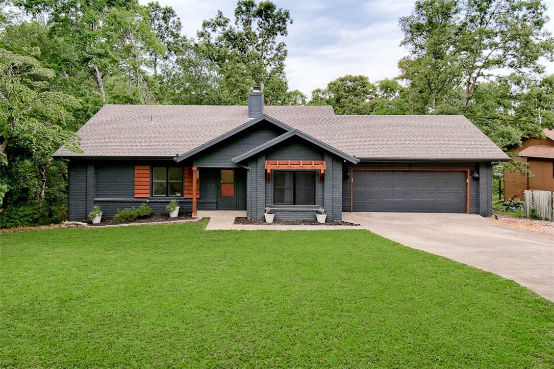 Completely renovated! This beautiful home sits on a .45 acre wooded lot just down the street from Loch Lomond Marina, Tunnel Vision Trail Crossing, and Scotsdale Golf Course. Brick & wood siding exterior (no vinyl siding!) Enjoy the warmth of a gas fireplace in an inviting open floor plan with maintenance-free LVP floors throughout (no carpet!). The modern kitchen features sleek 3cm granite counters and stainless steel appliances. The primary suite boasts a large walk-in closet, double vanity, and a luxurious walk-in tile shower. Step outside to a huge deck with serene wooded views—ideal for relaxation or entertaining. Additional storage building included! Don’t miss out on this perfect blend of comfort and adventure!