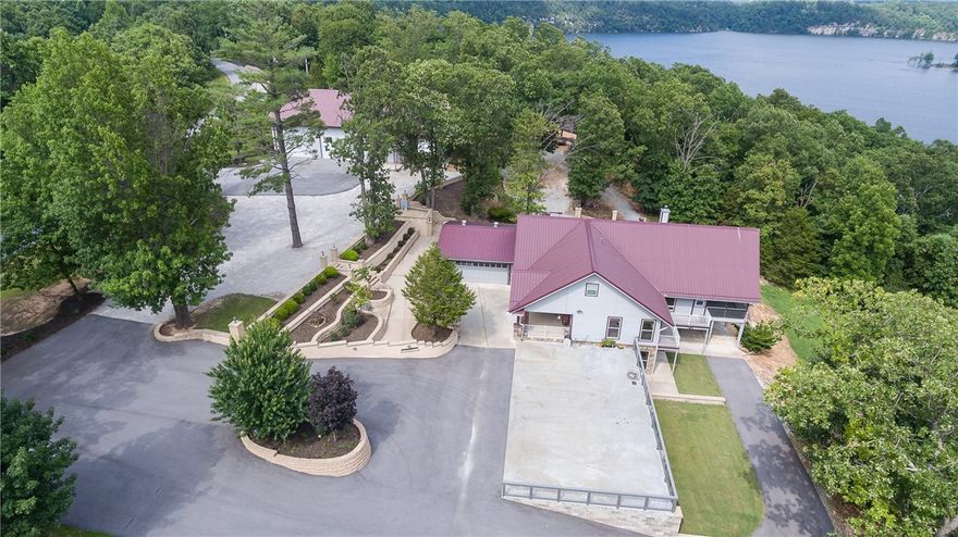 UNBELIEVEABLE VIEWS of Beaver Lake/Horseshoe Bend with private boat dock and 376" of zoned for docks frontage, from this 6.17 acre, 3 parcel property with a 2400 sf h/c workshop with living quarters.  3-4 bedrooms in house and potential MIL quarters in shop.  Views abound from every room.  Built like a fortress.  Granite, wood floors, tile throughout. Workshop has 4 bays with 27' opening.  32x15 screened in porch with grilling center, vented.  Professionaly landscaped.  Dock features 2 slips with swim deck.  20x40 carport on workshop for RV parking.  Home offers SS appliances, pantry, custom bar.  This home could be a primary or lakehome or a corporate retreat.  Plenty of space to build additional cabins or homes and to add docks. Home framed to add elevator to lower level or add on to free parking area with more living space.  You won't find a better view and be just minutes from downtown Rogers for dining and entertainment.  Close to schools, medical facilites, etc.  This is a must see.