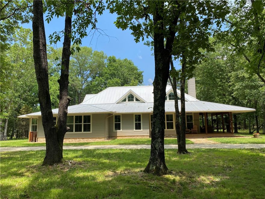 Welcome to your dream escape on Beaver Lake! This luxurious 2,475 sqft 2bed/3.5 bath home with detached oversized garage that's outfitted with 3rd bedroom suite and full bath combines elegance, quality and comfort in one. Many high-end finishes like Lp Smart siding, seamless metal roofing, a whole-house generator, storm shelter, no open soffits and more. Enjoy the warmth of exposed cedar lumber, wrap around porch, breathtaking views as you step into the spacious foyer space you will feel at home. Formal dining and all open living space great for entertaining, two spacious bedrooms both with private baths, primary suite is quite a treat has a spa-like bathroom, hydrotherapy ozone jacuzzi tub. The kitchen features an gas oven with air fryer, drawer microwave, breakfast bar, and all refrigerators included. All situated on 2.1 level acres encased with underground pet fence, two Full RV hookups, the property is a short and easy walk to the shared community dock with a boat slip and swim platform. Call today!