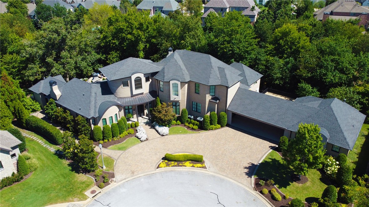 This meticulously curated, one of a kind, custom home in Pinnacle Country Club is unparalleled luxury. Nestled at the end of a quiet cul-de-sac on .92 wooded acres, it offers complete privacy while being minutes away from Pinnacle Hills and all the area and the country club has to offer. Experience the whimsical elegance of the hand forged metal stairway, and hand blown glass chandelier as you enter the foyer. View the custom pool through the store-front metal windows, watch the tropical fish in the salt water tank, take a ride down the slide to the media room, or stroll the gardens to the bocce ball court- there are so many ways to enjoy this home. The 528 SF guest house across the porte-cochere provides serenity for your guests. Top of the line Savant in home security/audio visual equipment stays hidden in command central, the safe room accessible from the master provides shelter from any storm. Grill outside by the pool with pizza oven, Big Green Egg while you luxuriate in your heated salt water pool.