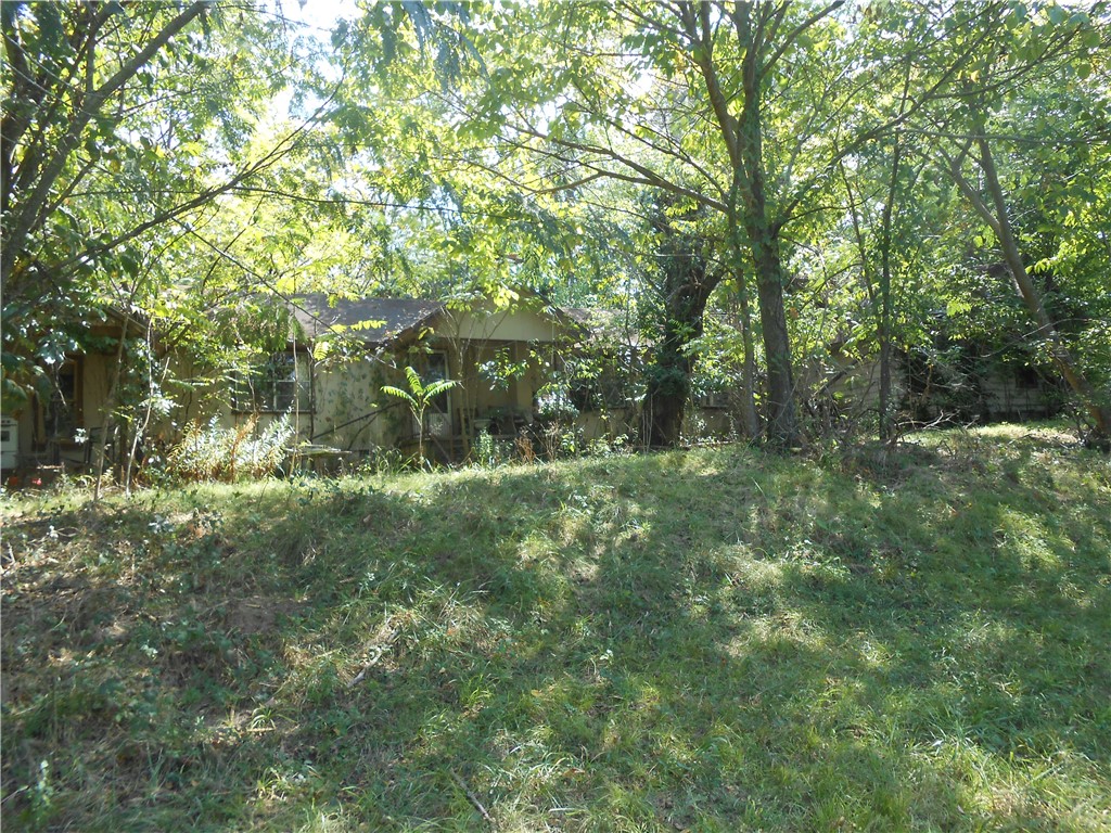 3.67 Acres heavy wooded with Electricity and Rural water on site. Old home and outbuilding in very poor condition - enter at own risk. Building sold "AS IS". May have existing septic.