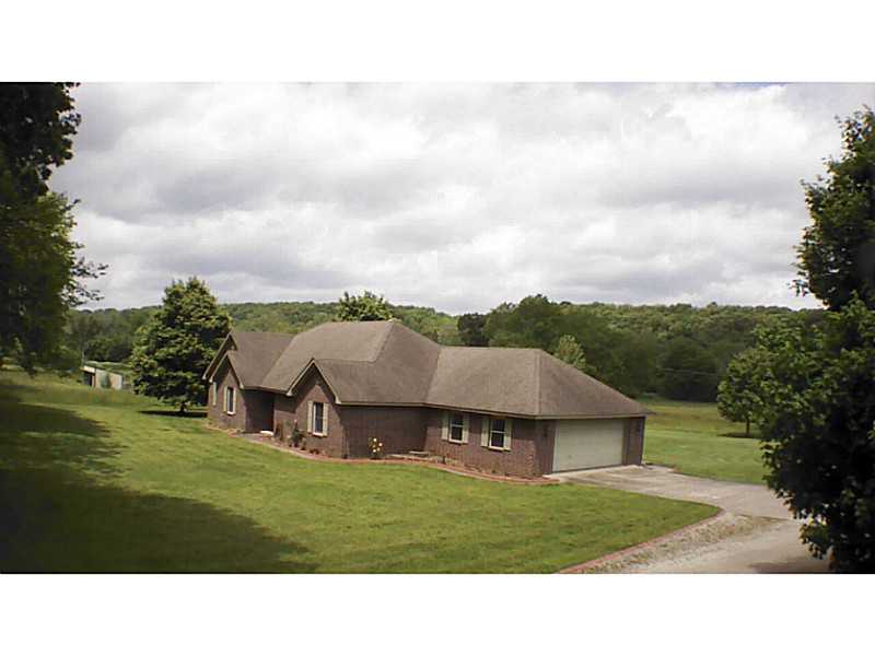 COUNTRY LIVING CLOSE TO ROGERS AND PEA RIDGE. Setting on beautiful Sugar Creek with 11 flat acres, is this one owner 4bedroom home built by Kim Wilson Builder.Pole barn for your toys or motorhome/shop and barn for the horses. This one is ready for its new,family. Survey in office. REDUCED PRICE