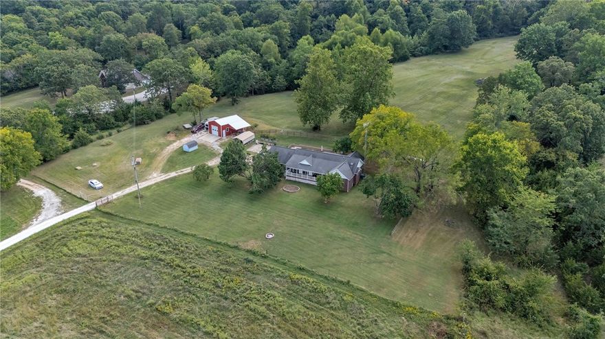 *** $10,000 seller credit towards closing costs, a rate buy down or your choice of updates!*** This beautifully finished home combines modern touches with a peaceful setting. The kitchen features soft-close cabinetry, pantry drawers, custom spice storage, leathered granite, black stainless appliances, and a farmhouse sink. The living room opens with double sliders to a spacious front patio where you can enjoy views of trees and wildlife. The ownerās suite offers a low-entry Onyx Collection shower with a frameless glass door. An oversized garage and a huge shop both include epoxy floors, while the HVAC is serviced twice yearly and the water heater is about five years old. Sitting on 19.99 acres, this property gives you space, privacy, and room to enjoy it all.