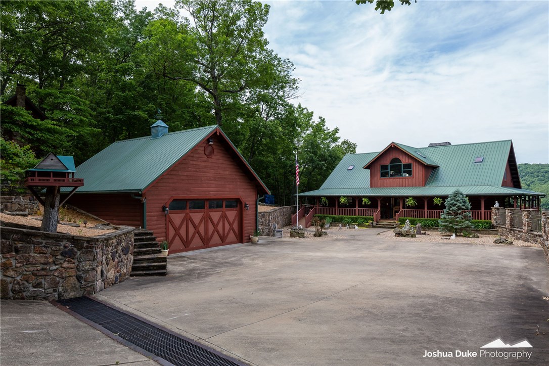 If you are looking for that perfect lake-front log cabin on paved roads? This one was featured in a magazine when built! Custom SatterWhite built log home, fashioned from dead standing timber to minimize maintenance. Stone path to boat slips (12' x 30' and 12' x 22') right out your door. One-owner home sets on 12.8 acres in the Indian Creek area. 144,000 board feet of knotty pine brightens up the interior. New gas cook-top, double-oven, floor to ceiling WB fireplace. 6 beds, 5 full baths. Handicap accessible lower level. Outdoor pavilion, elevated walkways, stunning waterfall, smile-enhancing kid playhouse, summer kitchen/fire pit. Whole house generator. Guest cabin secluded back in the woods was built to look like it was 100 years old, and it does; bark is still on the logs. Screened porch & fire pit, to watch nature as you relax. Inside boasts a massive WB fireplace. barn-wood kitchen cabinets, rustic flooring; it takes you back about a century. Most Furnishings & Taxidermy convey with accepted offer.