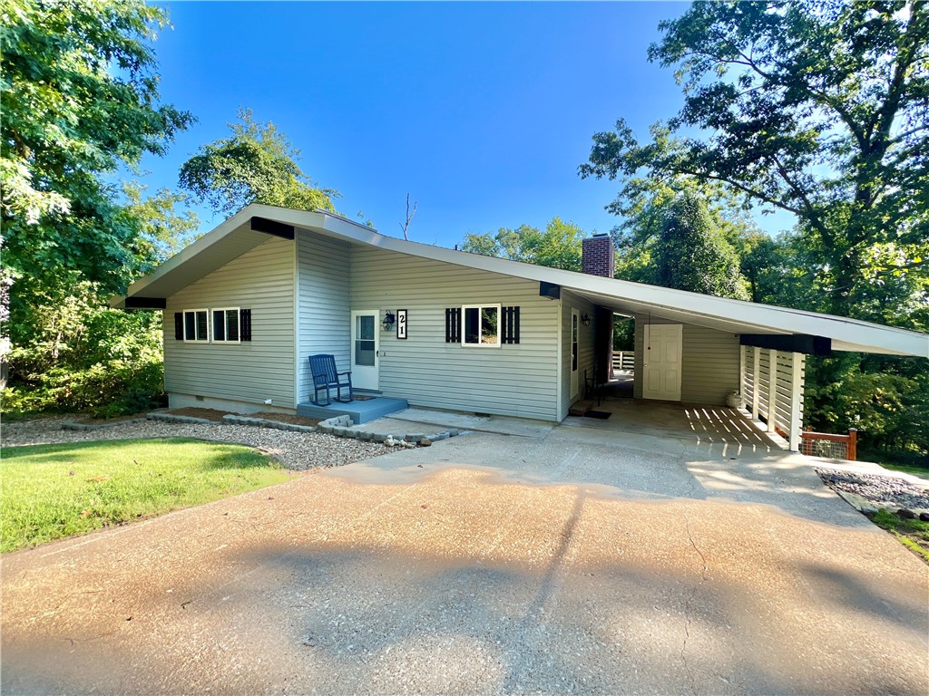 Discover this beautifully updated 2-bedroom, 1.5-bath home featuring an open floor plan. The kitchen has granite countertops and stainless-steel appliances. Enjoy cozy evenings by the wood-burning fireplace or unwind in the sunroom. The primary bedroom has a 1/2 bath and double closets. This home sits on a .78 acre double lot with a newly built custom fence surrounding the spacious backyard, offering privacy and plenty of space for outdoor activities. New landscape blocks added for potential flower beds or gardening. The back yard feels private with all the trees surrounding the property. All appliances convey, including a washer and dryer, making this home move-in ready. An unfinished walk-out basement with high ceilings and concrete floors provides endless possibilities for customization. The second lot perked for a 3 bedroom. New in 2020-Roof, dishwasher & stove. Donāt miss the opportunity to own this delightful property, combining modern convenience with classic charm!