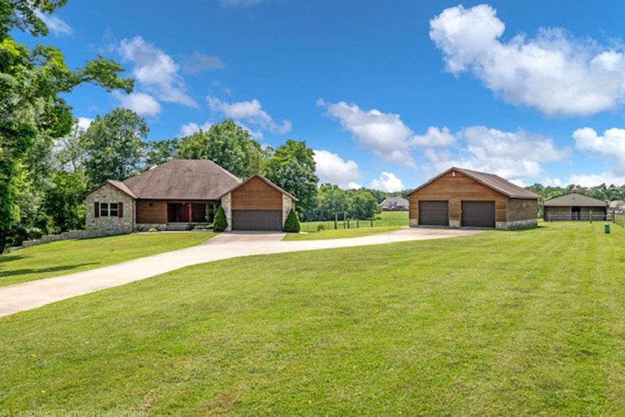 Spectacular property located in Benton County & zoned for Bentonville Schools! Only 10 mins to downtown Bentonville & easy access to WM HQ.  Nearly 3200 sq ft home with stunning hardwood flooring, open split floor plan, granite counters, SS appliances, whole house water chlorination system, Culligan reverse osmosis filter system in kitchen, stunning clawfoot soaking tub in the master bath, and a theater room downstairs!  12.86 acres for horses & livestock with a spring fed pond,  gorgeous organic garden, 6 car garage (2 car attached, 4 car detached) 30 x 40 garage/shop, 30 x 50 barn, & plenty of space for your RV!