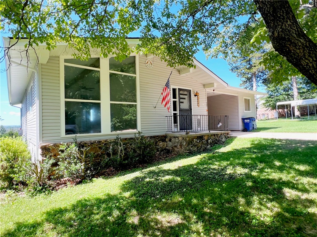 REFRESHED INTERIOR...LAKE COMMUNITY....CLOSE TO GOLF COURSE! What more could you ask for? This 2 BR 1 BA house has a lot of extras! Enjoy the golf course view from the sun room or back yard, all while only being just up the street for the beautiful waters of Bull Shoals Lake. New floor coverings, newer light fixtures, fresh paint, all ready to move right in. There is a one car carport/breezeway with a workshop office space attached. There is also a portable carport included. The back yard is fenced in so you can bring the dog with you! The fireplace makes it perfect for those cold winter days. All of this sitting on two lots. Perfect for your personal lake get away, the VRBO you have been thinking about, a couple just starting out or those empty nester's looking for peace and quiet! Let's go take a look!!