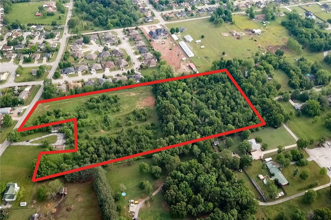 11 acres available of prime, flat land with major road frontage. This property is located just outside of the city limits. This means it is zoned A-1 with no Covenants or Deed Restrictions allowing multiple types of usage. Land is located just 2.4 miles from DTR (Down Town Rogers), and conveniently located 3 blocks from Old Wire Elementary. All Utilities are at the road. The Survey is located in the attachments. This is a rare find that will not last long! Sellers are highly motivated. Call for more information today! Ask about connecting property that will soon be available.