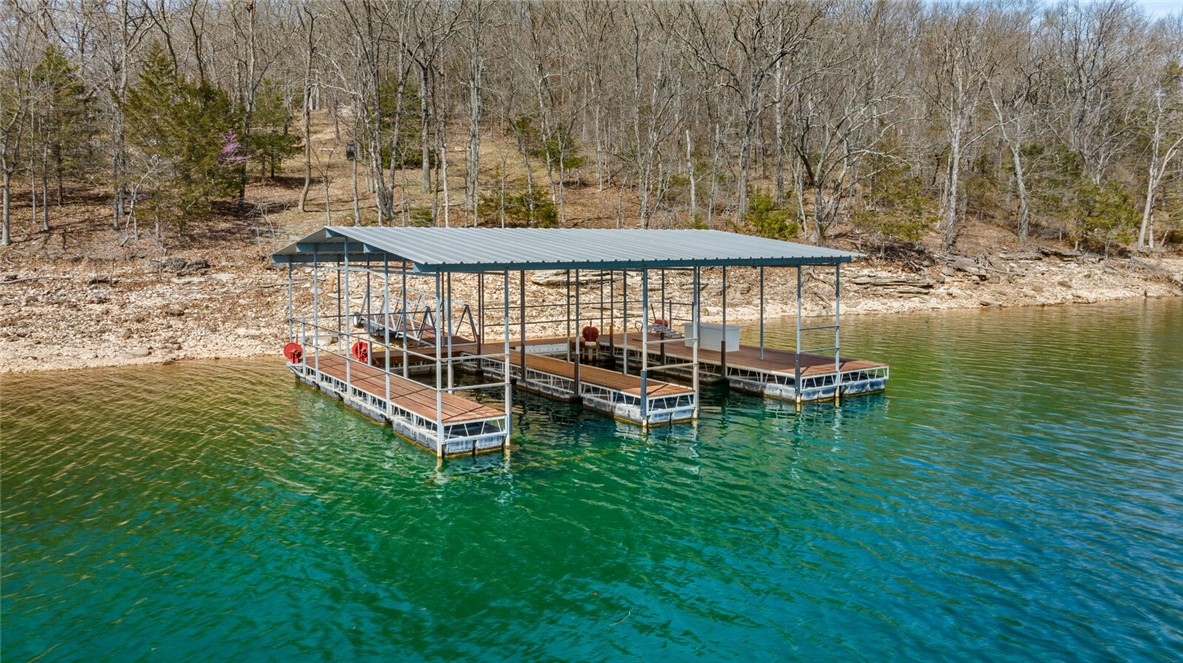 LAKEFRONT 2.61 ACRES WITH PRIVATE 2 SLIP (10X28 slips) BOAT DOCK!! The lots feature a moderate slope that allows for a walkout basement home and walk down access to the shoreline of beautiful Beaver Lake. The FOUNDATION has been poured for a 3,000+ sq. ft. 3 level home, and awaits your finishing touches. Nestled in a pristine setting, nature abounds, catching site of playful deer, red fox, wild turkey, and American Bald Eagles at one of the prettiest coves on the lake...Indian Creek! Build your dream home on the exceptional, one-of-a kind lot with panoramic views of Beaver Lake. This lot offers an unparalleled location and is the perfect canvas for your custom designed home. Experience the pinnacle of lake living where the serene waters of the lake meet the horizon, so you can immerse yourself in the tranquility of nature with beautiful sunrises painting the sky. Dreams "DO" come true!
Don't miss the chance to own a slice of paradise. Schedule your showing, and make this fabulous property your reality!