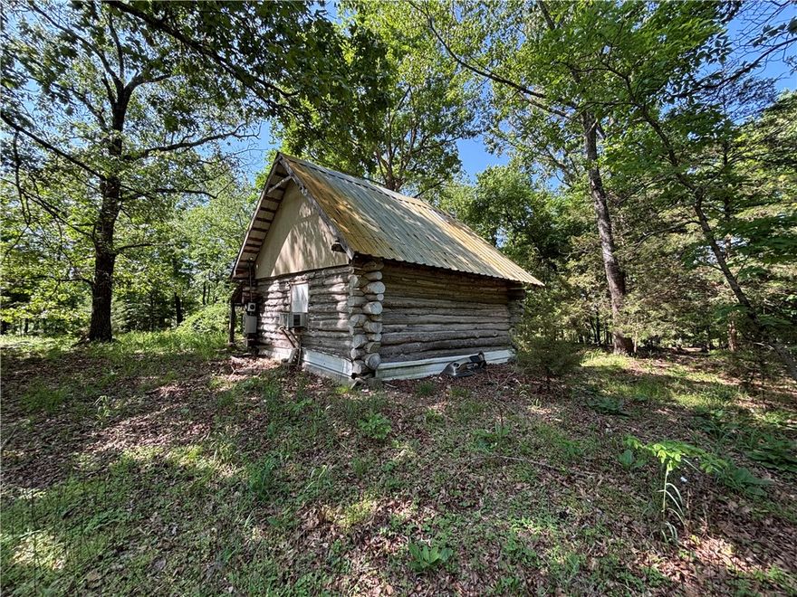 Neat primitive cabin getaway on 1.75 flat, mostly wooded acres. 20x20 cabin with a loft and front porch has OzarksGo/Electric and Rural Water is at the county road. Accessed by 500ft private road easement. Great getaway location for enjoying the outdoors. Great location close to all Northwest Arkansas has to offer. Utility availability is the responsibility of the buyer or buyers agent. Agent owned