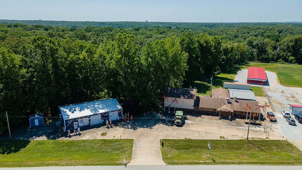 This unique property offers an excellent opportunity for business owners or investors. Located just 9 miles from downtown Rogers and near the intersection of Highway 62 & Highway 72, the property features two buildings totaling 8,015 square feet on 1.01 acres of land.
BUILDING 1: RESTAURANT/BAR (5,615 SF) The spacious restaurant/bar includes some existing bar equipment, tables, and chairs. It features a stunning custom oak bar that stands 8'8" tall and stretches 22' long, adding a touch of elegance to the space. The building is well-suited for a dining establishment, pub, or event venue. BUILDING 2:
SHOWROOM/STORAGE (2,400 SF) Next door, the showroom/storage building is equipped with a bathroom, electricity, and convenient roll-up doors. This space is ideal for showcasing products, additional storage, or even as a workshop. This versatile property is perfect for entrepreneurs looking to establish a presence in a high-traffic area or investors seeking an attractive commercial asset.