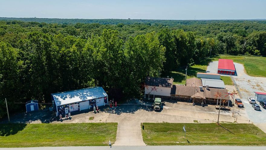 This unique property offers an excellent opportunity for business owners or investors. Located just 9 miles from downtown Rogers and near the intersection of Highway 62 & Highway 72, the property features two buildings totaling 8,015 square feet on 1.01 acres of land.

BUILDING 1: RESTAURANT/BAR (5,615 SF) The spacious restaurant/bar includes some existing bar equipment, tables, and chairs. It features a stunning custom oak bar that stands 8'8" tall and stretches 22' long, adding a touch of elegance to the space. The building is well-suited for a dining establishment, pub, or event venue. BUILDING 2: 

SHOWROOM/STORAGE (2,400 SF) Next door, the showroom/storage building is equipped with a bathroom, electricity, and convenient roll-up doors. This space is ideal for showcasing products, additional storage, or even as a workshop. This versatile property is perfect for entrepreneurs looking to establish a presence in a high-traffic area or investors seeking an attractive commercial asset.