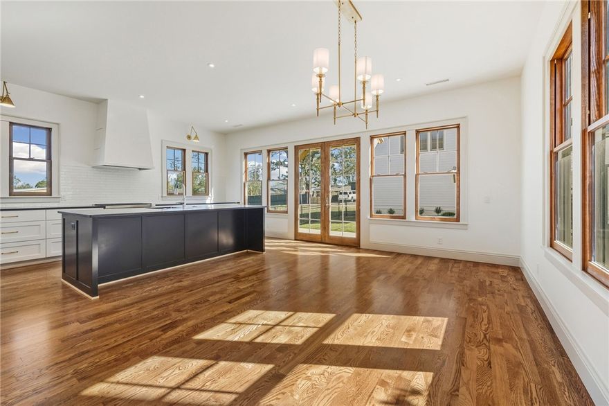 Welcome to the Magnolia House at Arboretum Row, the second of five new luxury homes (2025) in Downtown Bentonville adjacent to the Burns Arboretum at Park Springs Park. First level features a cozy living room with fireplace and spacious kitchen and dining featuring 42" SubZero Fridge and 36" Wolf dual fuel range. Don't miss the "secret" wine room and pantry tucked into the kitchen paneling. Warm white oak floors and aluminum-clad wood windows throughout. Primary suite with heated tile and marble shower upstairs, plus two additional bedrooms and shared hall bath. Main house: 2,112sf, 3bed/2.5ba. Guest house: 693sf, 1bed/1ba over detached 2-car garage. Sunny patio and lawn with irrigated landscape on 0.14 acre lot. Walk to Airship Coffee, the Square, Crystal Bridges, and Park Springs Park trails.