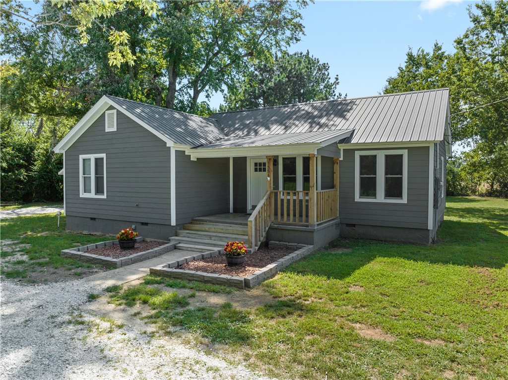 Welcome to this charming home nestled on over an acre. The completely renovated 3 bed, 2 bath home includes new flooring, windows, electrical, plumbing, HVAC, roof, and more. An open concept living area flows into the kitchen which features granite countertops, ample storage, and stainless steel appliances. The main hallway branches off to three spacious bedrooms. Enjoy the welcoming front porch to relax and take in the beauty of the Ozarks. Additionally, off of the back deck you'll discover an oversized detached garage. The secluded feel paired with the completely updated home offers the best of country living and modern comfort!