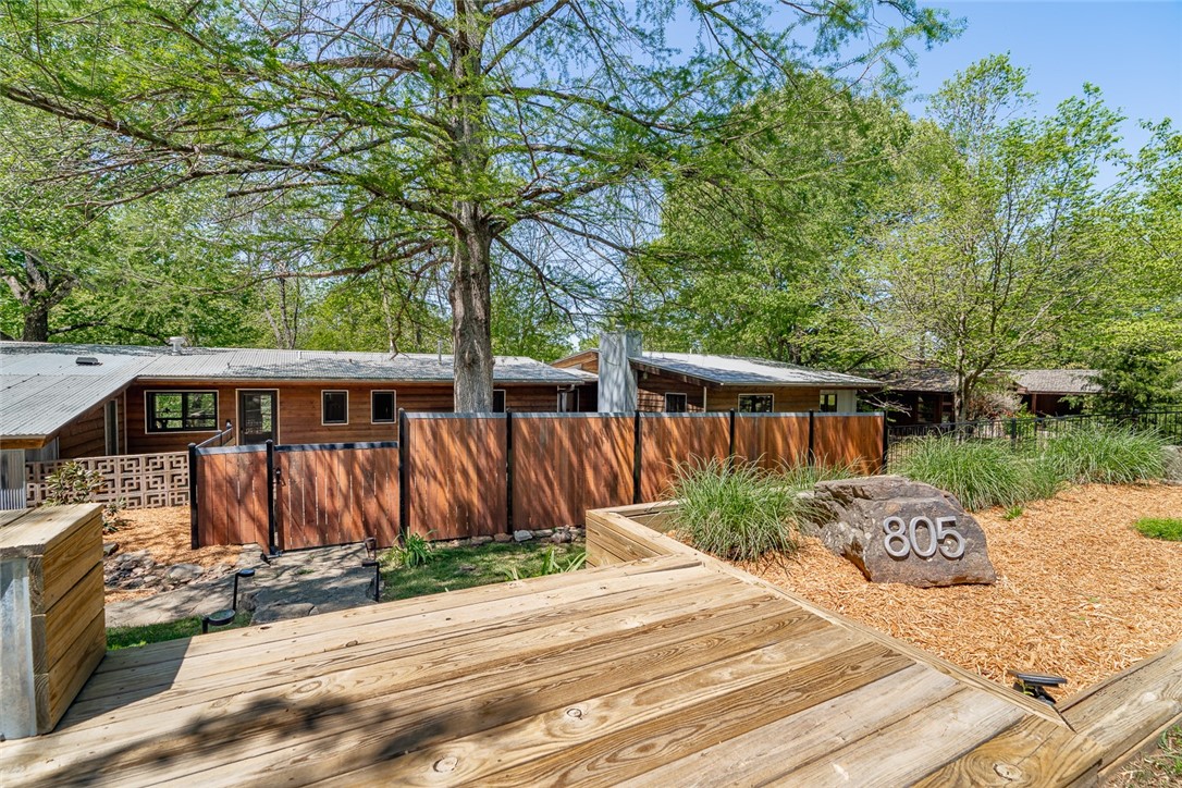 You must see this beautifully remodeled home nestled among the trees on the coveted Mount Sequoyah! As you step inside, you will find a bright and airy floorplan that features stunning slate floors in the open living and elegant kitchen area. This 3 bedroom charmer is filled with natural light sits on .77 acres and is surrounded by landscaped gardens, large private patio, multiple decks overlooking beautiful trees, babbling brook and seasonal flowers. The primary bedroom is an oasis all on its own! Enjoy your morning coffee by the cozy fireplace or step outside to the lovely screened in patio. This unique home is like nothing else on the market. Enjoy the convenience of living in the heart of Fayetteville with access to the Greenway Trail System, minutes to the downtown square, restaurants, shopping, entertainment, schools and parks. Come home to 805 N. Crest Drive!