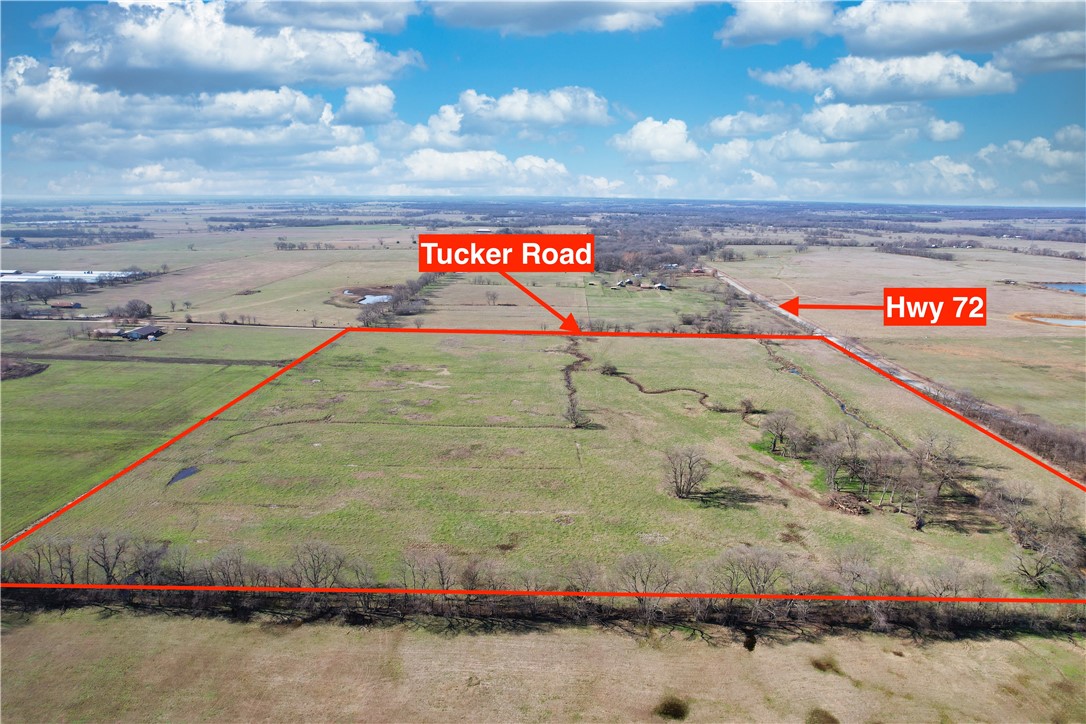 You Found It! The land you have been searching for! This level and cleared 40 acres with a few scattered trees has frontage along state Highway 72 and Tucker Road. It's only a 25 minute drive to Bentonville via accessing Interstate 49 east of Gravette and exiting at North Walton Blvd. in Bentonville. It is only a 7 minute drive to Gravette and 25 minutes to Siloam Springs. This picturesque property has a year round creek the entire length of the property which is a fresh source of water for your cattle or other animals or a place of recreation for you and your family. The acreage has fencing on all four sides with two gates to access the property on the corner of Tucker Rd. and Highway 72 and on the SW corner of the land along Tucker Rd. There are plenty of options on the property to build your dream home and rural water is available at the road. Enjoy the quiet lifestyle of country living yet only minutes from everything you need! Check out the video tour on the virtual tour link. Schedule your private tour today!
