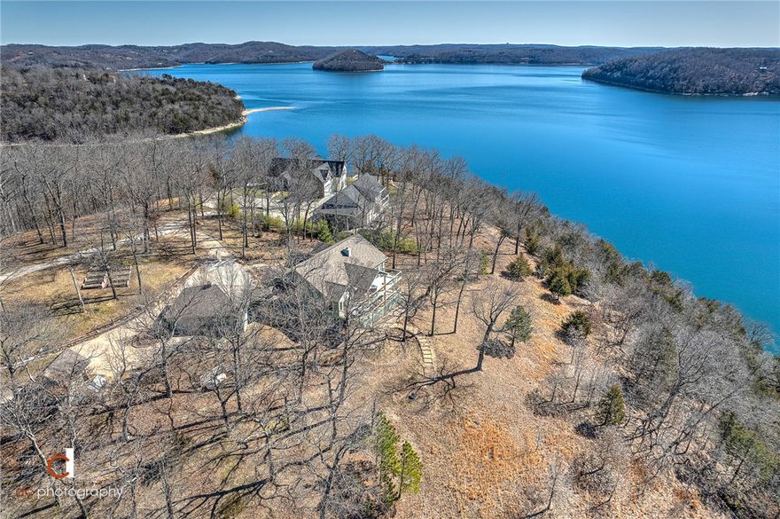 Year Round Lake View Home with a slip in a community Dock. This home has water views from the majority of the rooms in this home plus upper and lower decks for outside enjoyment.  You are minutes by water to Starkey marina and some of the best coves on the lake. The  home has a fantastic kitchen with great flow to the living room and outside deck.  You will enjoy dinning in the breakfast area or outside and watch all the lake has to offer. Also on the main level is a formal dinning, office and master suite.  There is an elevator along with stairs for easy access downstairs for the 2 spare bedrooms and another living area along with the lower deck.  There is a breeze way that connects the home to the 3 car garage all of this sitting on 3 water front acres.