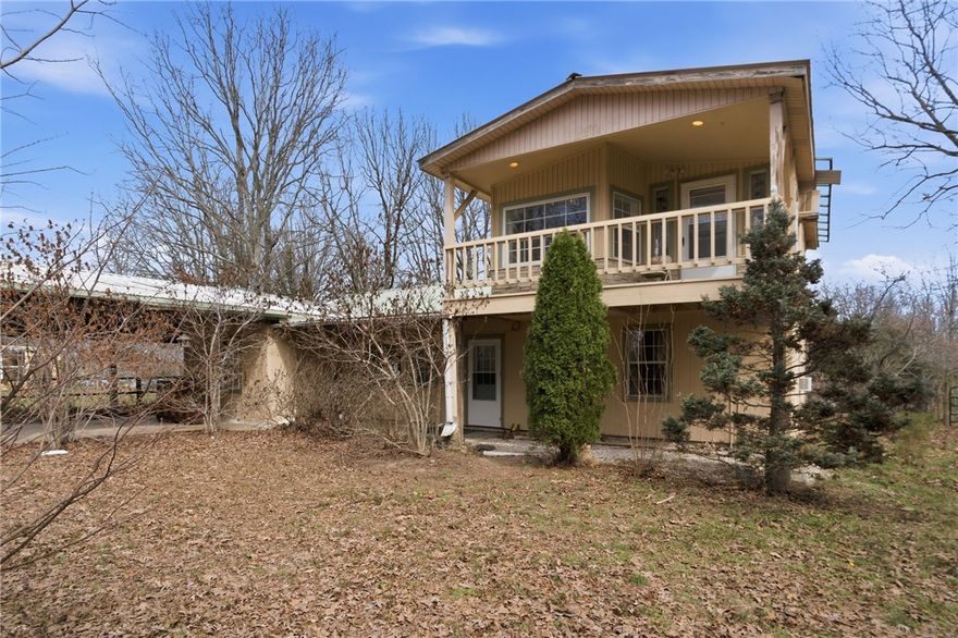 Tucked on approx. 5 acres of pasture and woods, this 3-bed, 3-bath is a rare find for those craving space and self-sufficiency. The main home features a sunroom, huge pantry, vinyl plank & tile flooring, wood cabinets, and central HVAC plus wood-burning stoves. The second story includes a third bedroom with its own wood stove, walk-in closet, and decks from front and back overlooking the property. Double porches, metal roof, fruit orchard, stocked pond, and an 8x8 storm shelter round out the outdoors. The 320 sq ft studio is perfect for guests, rental income, or a home office. Workshop/garage has power and built-in benches. A chicken coop, fenced pastures, and a greenhouse — once used commercially — make this a hobby farmer's dream. All appliances except the refrigerator convey, plus the chest freezer. 8 min to Winslow, 15 min to West Fork, 35 to U of A. Note: County records currently show 17 acres; a survey is pending to divide the property — approx. 11 acres will sell separately.