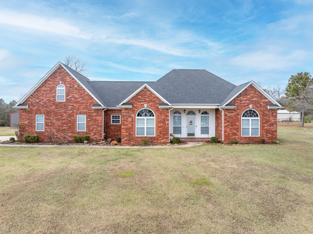 Spacious 3 or 4 bedroom home on 3+ acres just outside of Ozark. This split bedroom plan is very clean and move-in ready. Kitchen features solid surface countertops, ample cabinetry and two pantries for additional storage. Eat-in kitchen plus formal dining. Built-in desk just outside the master bedroom. Master suite has dual vanities, a large walk-in closet, whirlpool tub and separate shower. Upstairs bonus room would make a great 4th bedroom, playroom or home office and has its own private bath. Concrete saferoom in the garage. Sunroom looks out into the fenced backyard. 30x40 storage building with lean to on one side. High speed internet available ( Wave Rural Connect).