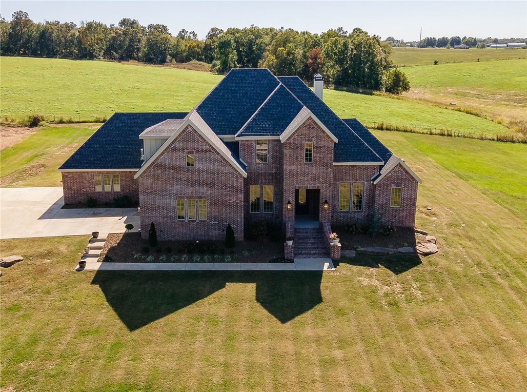 Looking for quality new construction but do not want to build??? Here is your chance to own a just like new home in a prime location situated on 1.79 acres! 3,691 heated square feet includes 4 bedrooms, 4 full bathrooms, study, formal dining, oversized living room open to eat in kitchen, large laundry, mud room, and a bonus room (which offers a closet and could be a 5th bedroom). Amenities include hardwood floors, wood burning fireplace, cabinets to the ceiling in kitchen, brushed 3 cm granite, walk in pantry, double ovens, 5 burner gas range, mud room lockers, and large covered patio. Extra special features include 2 bedrooms on the main floor, an amazing 4 car garage of which 1 is heated and cooled with a mini split, and an abundance of walk in attic storage. The property offers a country feel with a 20 minute drive to Fayetteville or a 20 minute drive to Bentonville!!! Zoned for Harber HS.