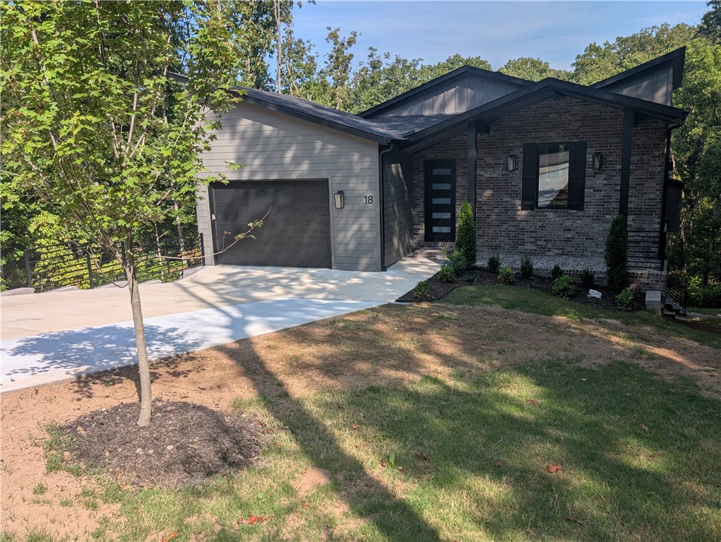 Discover luxury living in this brand-new modern home. The 3-bedroom, 2.5 bathroom residence showcases premium features throughout two HVACs with smart Ecobee thermostats. The gourmet kitchen boasts leathered granite countertops, a scratchless composite undermount sink, and soft-close cabinetry. Elegant touches include concrete quartz surfaces and Delta fixtures. The master suite features a curbless shower, while an energy-efficient tankless water heater and insulated 8-foot garage door with belt drive opener add practical value. The large 1 and 1/2 car garage gives you plenty of space to park a car and your golf cart. Extra large driveway provides parking for multiple cars. Spacious walk-in storage area under the house for abundant storage. Custom metal railings on both outside decks and interior stairs. Property backs to Tunnel Vision Trail and is just a five-minute walk to Lake Avalon. This masterfully crafted home combines modern luxury with practical amenities in a sought-after location.