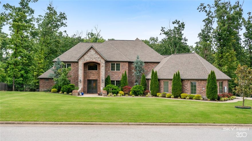 PRICE REDUCTION!!! This one won't last. Too many features to call out. Stunning home on an acre lot in Versailles Centerton. ~4 miles away from Walmart HO. This contemporary beauty features spacious areas, plenty of natural light, high-end finishes, iron doors, tall ceilings and wood floors throughout. Master Suite, Office, Kitchen, living area and guest bedroom are located on the main level. All other bedrooms, media room and unfinished space are on the second level. Pinewood tray ceiling, tall windows overlooking the pool and woods, designer sinks, walk-in closets, tiled shower offer luxury and privacy in the Master suite.  Chefs dream kitchen includes granite countertops, maple custom cabinets in walnut finish, large island, gas range with 6 burners and grill, walk-in pantry, wooden vent hood and ceiling accents. Imagine a summer afternoon in a 9' gunite saltwater pool, deck and cooking in the back patio kitchen near the stone firepit. Fruit trees, irrigated yard, French drains and this home has a lot to offer.