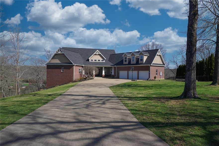 Fantastic location for privacy & spectacular views, only 15 minutes to Downtown Bentonville & very close to Coler bike & Lincoln trails. Extensive decks to view surrounding wildlife, red-tailed hawks & bald eagles fly by close enough to see the color of their feathers. Custom built home reflects quality & attention to detail throughout. Soundproofing is added for those who work at home. Step out back to the unique massive stone patio & firepit for relaxing at home or intimate open air entertaining. The dining room & two family rooms walk out to spacious decks. The downstairs functions either as an in home retreat or guest suite, while the upstairs is a secretive but roomy bed & bath. Don't miss this vibrant home with a view.