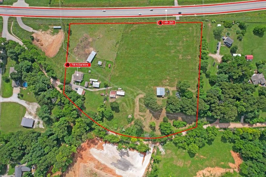 Great opportunity to purchase 9.28 acres with approximately 700 ft. of frontage to highway 265 in Lowell area.  Just outside the current Lowell city jurisdiction.  Current zoned residential/agricultural but could easily go commercial. There's already one entrance to 265 and one entrance from Old Wire Rd.  There are several structures on the property.  The sellers would like to take part of the barn, if possible.  There's a house on the property with a relatively new roof on it, but the value is primarily in the land.  The house will be available for showing/inspection with accepted offer.  The sellers need 60 days delayed occupancy to remove their farm equipment and belongings.  Also listed as land.