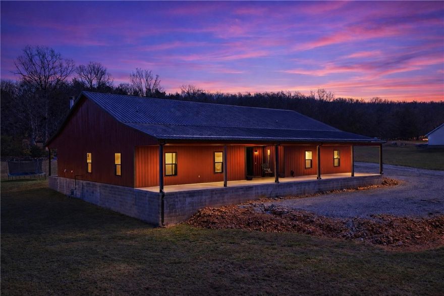 Welcome to your private retreat on 5.01 acres! This stunning 3,612 sq ft energy - efficient Barndominium-style home offers the perfect blend of modern comfort and wide-open living. Featuring 3 spacious bedrooms, 2.5 baths, a dedicated office, and a versatile interior bonus room originally designed as a tornado safe room, this home delivers both flexibility and peace of mind. The open-concept layout is ideal for entertaining, while the 2-car attached garage provides everyday convenience. Step outside to enjoy a beautifully wooded backdrop that adds privacy and a serene country feel. Need additional space? The impressive 1,800 sq ft shop/guest house includes 780 heated sq ft with 2 bedrooms, 1 bath, and a private office—perfect for guests, extended family, rental income, or a home-based business. Featuring oversized 12x14 RV doors, it’s ready for all your toys, equipment, or hobbies. This property offers the rare combination of luxury living, acreage, and versatility—all just waiting for you to call it home.
