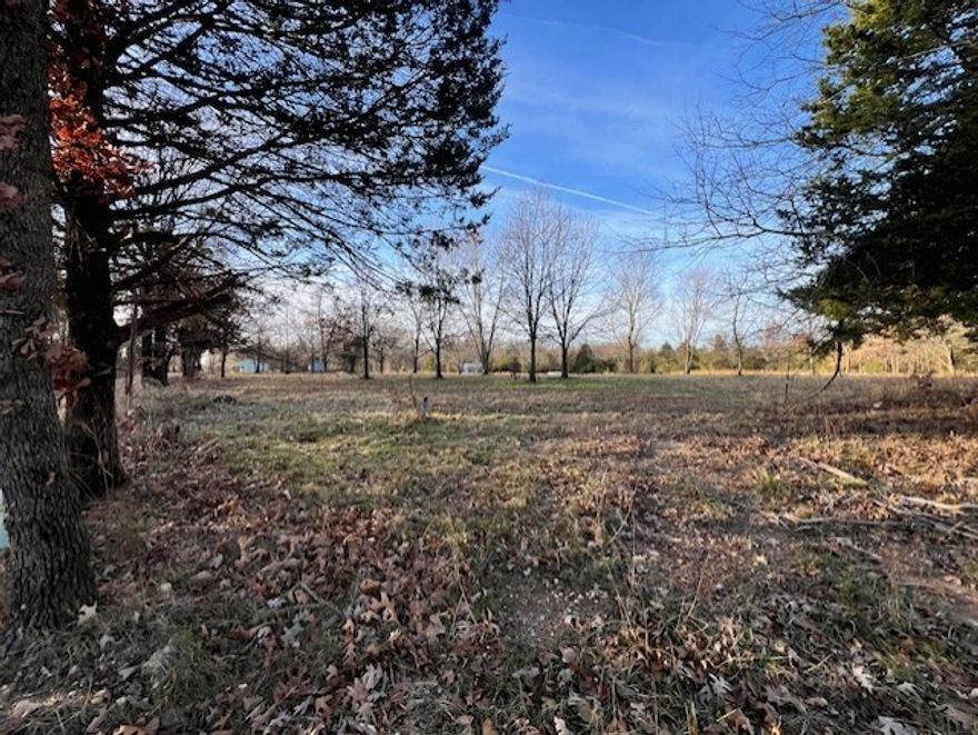 Discover the perfect setting for your dream home on this beautiful 3.5-acre parcel, offering the ideal balance of open space and natural charm. The land features mostly level land with gentle contours and some mature hardwoods while remaining mostly open—perfect for designing a custom home, outdoor living spaces, and enjoying wide-open views. A 4-bedroom septic system is already installed, saving time and expense, with public water and electricity conveniently available at the street. Located just far enough out to enjoy peace, privacy, and quiet surroundings, yet still close to shopping, dining, and everyday amenities. Whether you’re envisioning a private retreat, a modern farmhouse, or a timeless country estate, this property provides a rare opportunity to build exactly what you want in a serene, accessible location.  Subject to recorded parcel split.