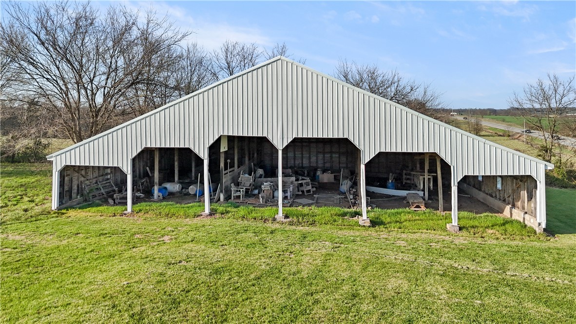 View of pole building featuring a lawn