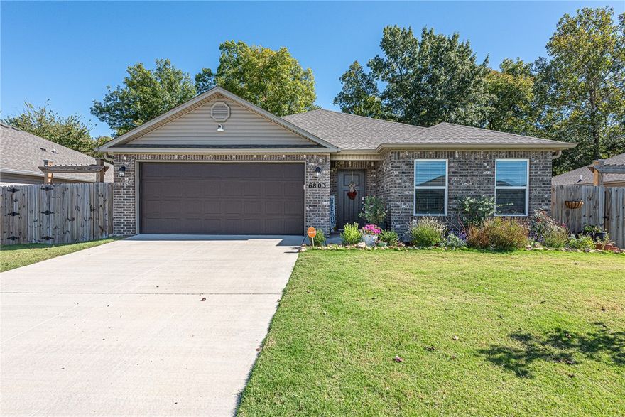 This 3 bed 2 bath home in Bentonville is minutes away from XNA, parks, schools, and community center! Less than 8 miles from Downtown Bentonville, new Walmart campus, and I-49! From the covered front entry head into an open concept living space with luxury vinyl plank flooring, an  L-shaped kitchen featuring white cabinetry, subway tile backsplash, stainless steel appliances, pantry, granite countertops, large island with room for additional seating, and eat-in dining space! BONUS - All appliances convey! Relax and rejuvenate in the primary suite with dual  sink vanity, jacuzzi tub ,walk-in shower, and walk in closet! Enjoy an additional two bedrooms and one full bathroom. Head out back to the covered back patio over looking your fenced in back lawn with mature tree and scalloped picket fence which backs up to a wet weather creek. Don’t Miss out! Act Now!