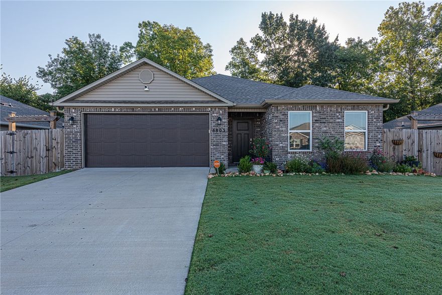 This 3 bed 2 bath home in Bentonville is minutes away from XNA, parks, schools, and community center! Less than 8 miles from Downtown Bentonville, new Walmart campus, and I-49! From the covered front entry head into an open concept living space with luxury vinyl plank flooring, an  L-shaped kitchen featuring white cabinetry, subway tile backsplash, stainless steel appliances, pantry, granite countertops, large island with room for additional seating, and eat-in dining space! BONUS - All appliances convey! Relax and rejuvenate in the primary suite with dual  sink vanity, jacuzzi tub ,walk-in shower, and walk in closet! Enjoy an additional two bedrooms and one full bathroom. Head out back to the covered back patio over looking your fenced in back lawn with mature tree and scalloped picket fence which backs up to a wet weather creek. Don’t Miss out! Act Now!