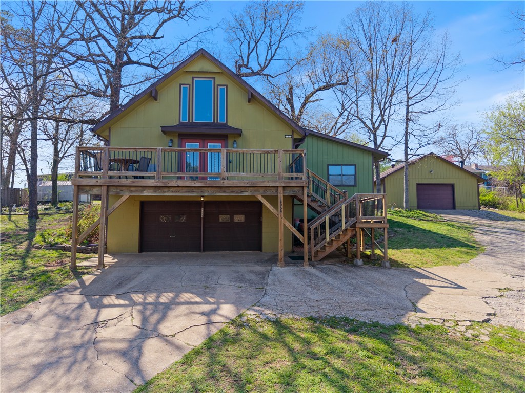Welcome to 8059 Elm Lane. This home has so much to offer! 3 level home with attached two car garage AND additional shop with wood heat. Imagine coffee on the deck listening to the birds and boats, working in the garden and then soaking tired muscles in the hot tub. On chilly days, build a fire in the woodstove, hop in the hot tub and the house is toasty too. The yard is landscaped with rock flower beds and greenery and there is even a little trail on the property. Open floor plan with gorgeous cathedral ceiling and windows. Home was recently refreshed with paint, flooring, light fixtures and gutters. With the extra parking and additional lots, there is plenty of space for whatever you might need.
