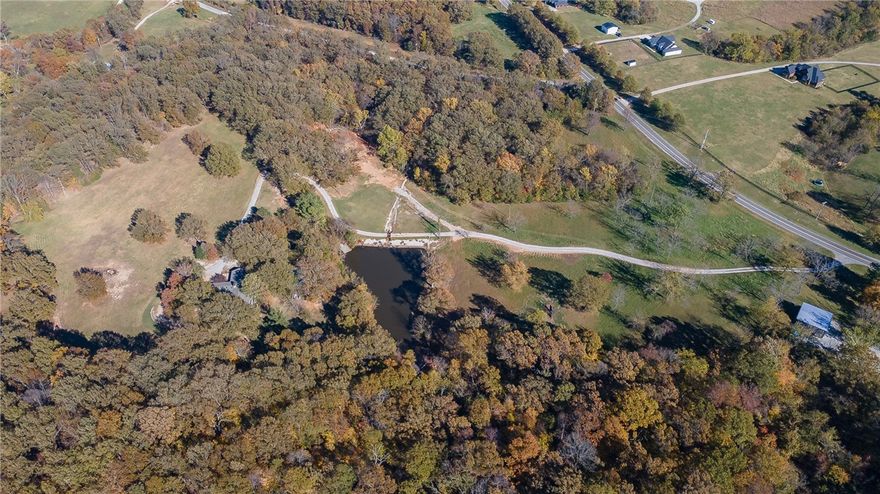 Don't miss this absolutely stunning 42 acres in Goshen only 20 minutes to Fayetteville. Privately tucked on the property is a 1-owner 2650 sqft 3 bed, 3 bath home on 1-level that has been newly renovated. Featuring luxury vinyl tile flooring, fresh whole house interior paint job, wood casement windows,  brand new roof, and 1-year old HVAC, the chef's kitchen and living room showcase an extremely well built frame. The fire place is ducted to the HVAC and can supplement heat if desired. The covered/vaulted breezeway is perfect for outdoor living and connects the 4 car garage, with a 2 door pull through lane for a boat, and the home. Outside you'll find a black bottom pool, gazebo, fire pit and trail leading down to the large fishing pond with a pier. The land has flat and rolling  topography and both forest and pasture making it perfect for a hobby farm, hunting or additional homesites. House is on a great well but does have a public water tap down by the entry. Way too many features to list here. This is a must see.