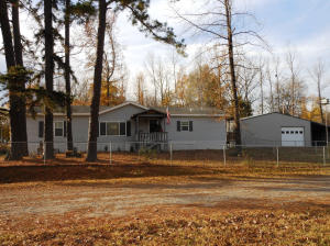 Enjoy this attractive lakeside home (Carter Cove Community) on Nimrod Lake with chain link fenced yard. Excellent fishing and hunting. Includes a large heated and cooled shop, side shed for boat parking, enclosed rear shed for side by side, lawnmower, etc., Vehicle canopy with enclosed storage. Also a separate storage building. Not your typical manufactured home. Dry wall, etc. finished on site.