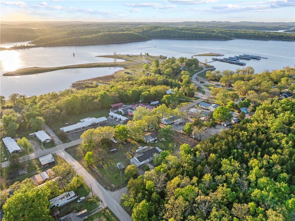 Welcome to 321 Blackwell St in Diamond City—your ideal lake getaway! This 2-bedroom, 1.5-bath home sits near Bull Shoals Lake and features a fully fenced, landscaped backyard, garage space for your boat and lake toys, and an additional bay perfect for a side-by-side or golf cart (which are street legal here!). Both bedrooms offer access to a cozy sunroom—great for relaxing after a day on the water. The property also includes an RV hookup, making it ready for guests or lake weekends on the go. You'll love the upgraded electrical with a separate 200-amp panel in the garage, plus a brand new roof and metal fascia installed in December 2024. Water heater, propane tank, & propane lines replaced within last 3 years. Move-in ready and made for lake life!