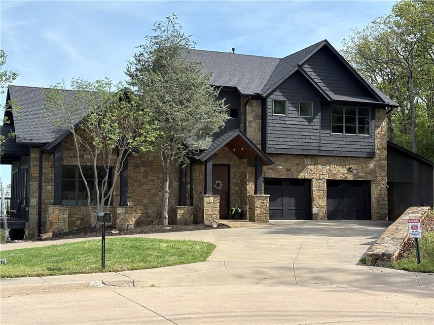 Experience the most gorgeous views in Fayetteville from this custom estate nestled on a private cul-de-sac perched atop 6 +/- acres in the heart of Fayetteville! Yes, 6 acres! Enjoy sunrises and sunsets flooding natural light throughout this lodge like extravagant estate. Luxury begins with the steel offset hinged front door that welcomes you to a grand entrance with solid wood plank floors that take you to the dream kitchen with quartz counters, walk-in pantry and high-end appliances. Kitchen opens to the great room with soaring ceilings, solid wood 8 foot doors with real wood beams across the ceiling. Soak in the stunning views of Fayetteville, U of A and NWA from the many covered and uncovered wrap around decks and wildlife is abundant as well. Two bedrooms on main floor as well full bath and powder bath. The private retreat features the best views in the home with a spa-like ensuite and expansive walk-in-closet. Two more bedrooms for kids or company and big flex room, gym or media room. New roof / gutters 2023.