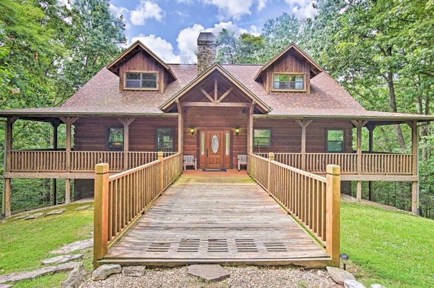This 3340 square foot 3 story 4 bedroom 3.5 bathroom home comes FULLY FURNISHED (including pool table and video game arcade console) in a unique gated cabin development in NW Arkansas.  This Satterwhite built home's interior is designed with full cedar logs and Engelman spruce knotty pine walls throughout.  A steady stream bubbles out back as you're surrounded by tall trees providing a peaceful setting and comfort while relaxing on either one of the two wrap around porches.  Take advantage of the fishing and hiking nearby too!  This home is currently on an VRBO listing providing additional income.  Two new HVAC units installed in 2024.